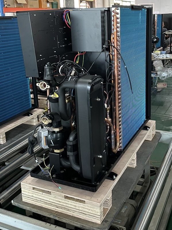 Rear of a heat pump unit showing the blue-fin evaporator coil, circulation pump and insulated hydraulics