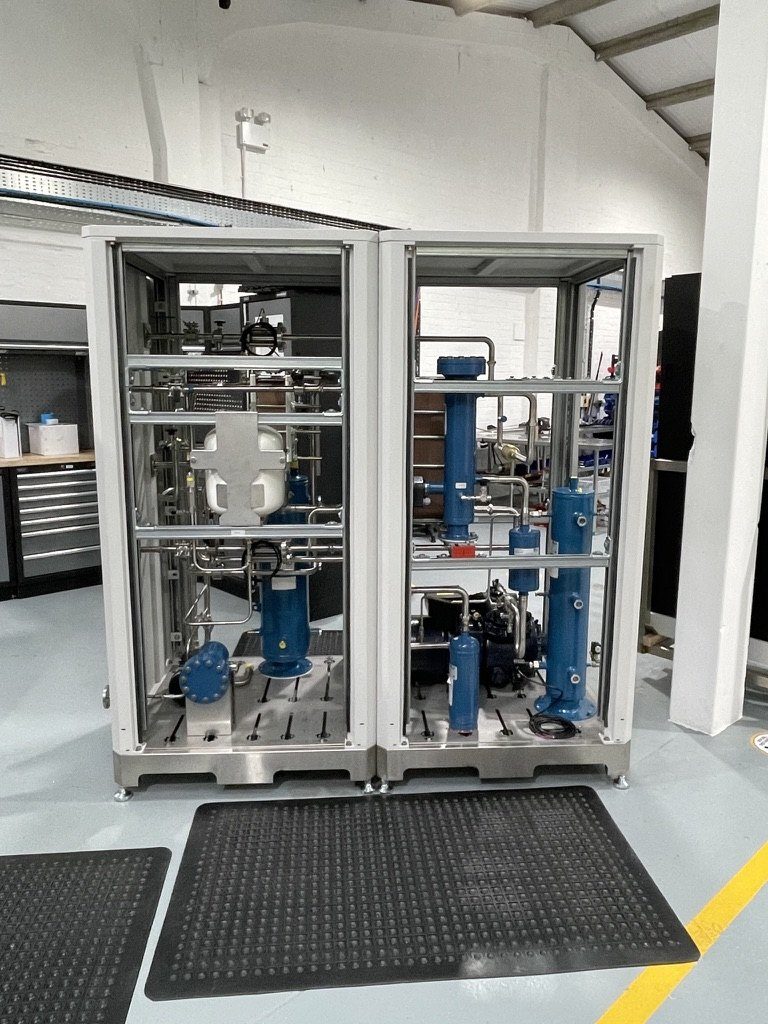 Two open aluminium module frames with blue refrigerant vessels and stainless pipework