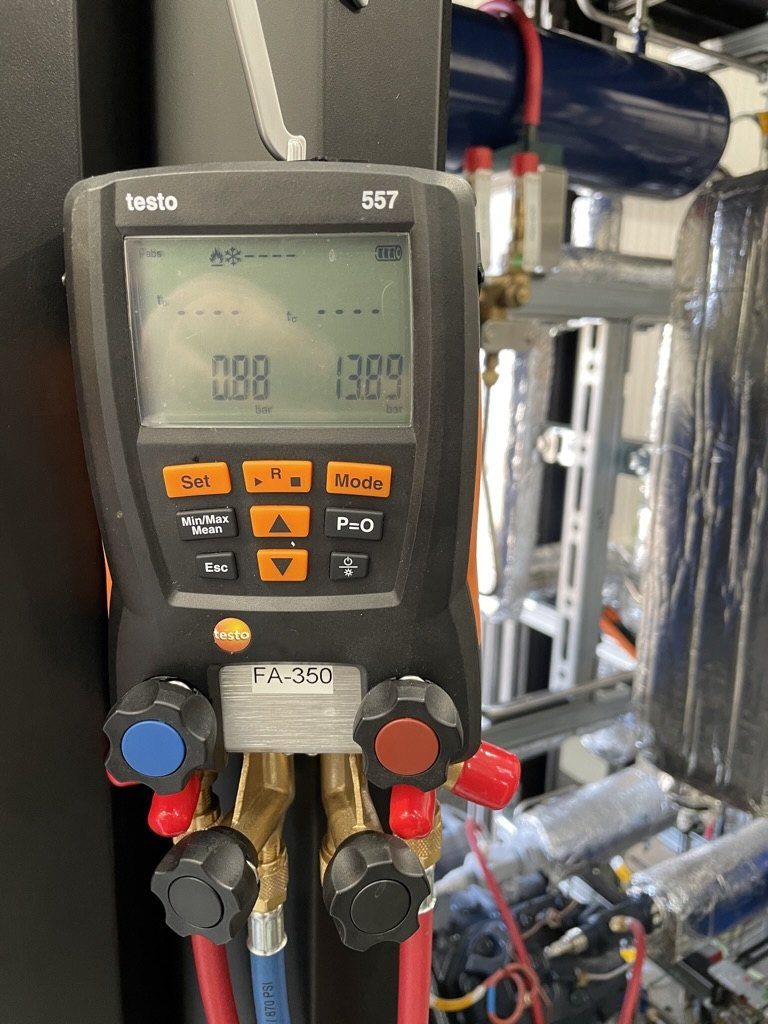 Digital refrigeration manifold gauge showing suction and discharge pressures